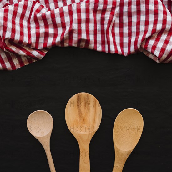 Wooden spoons near napkin