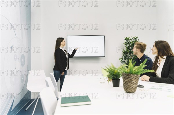 Young businesswoman giving presentation office