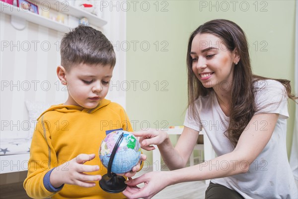 Young mother teaching son