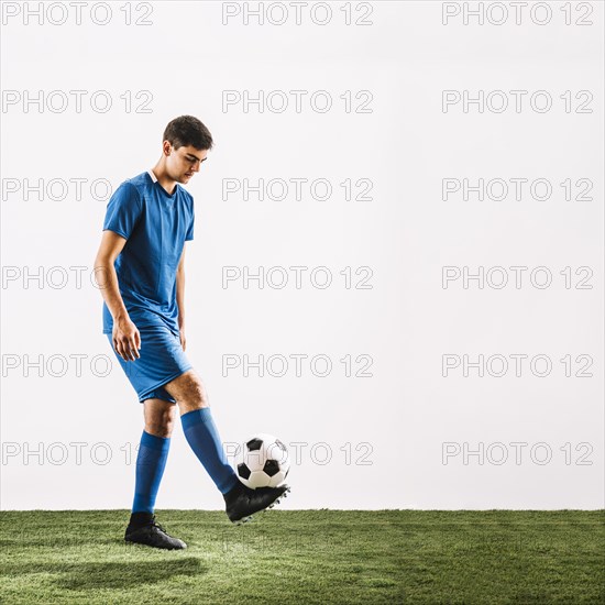 Young sportsman juggling ball