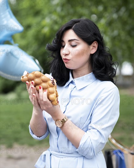 Young woman eating bubble waffle