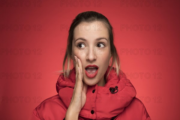 Young woman red winter coat shouting sign