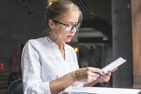 Young woman working document restaurant