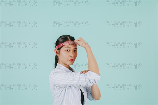 Asian woman showing biceps