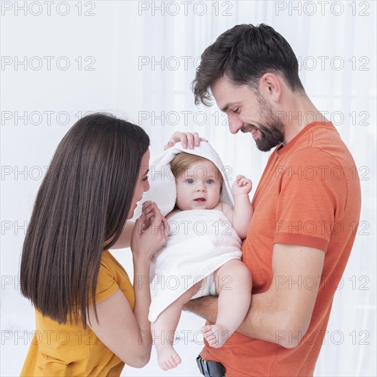 Baby towel held by parents