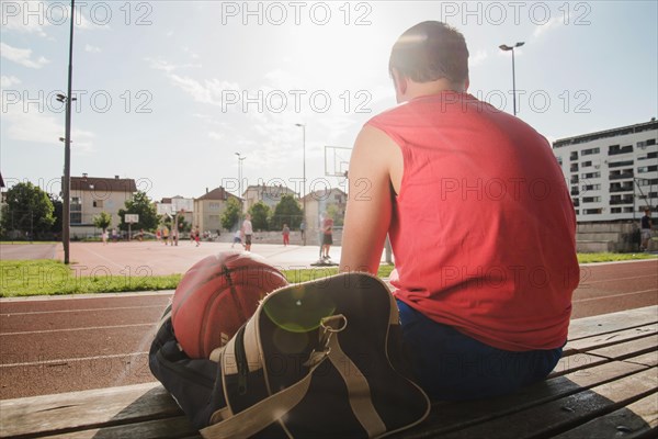 Basketball player sitting sports court