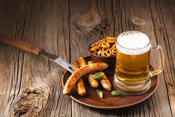 Beer mug with sausage snacks wooden board