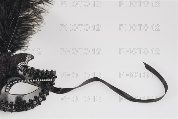 Black carnival mask with feather light table