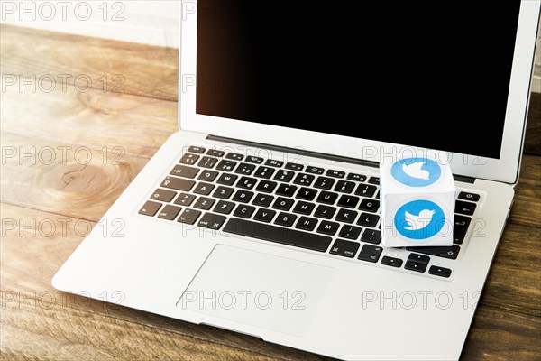 Blank laptop with box twitter icon work desk