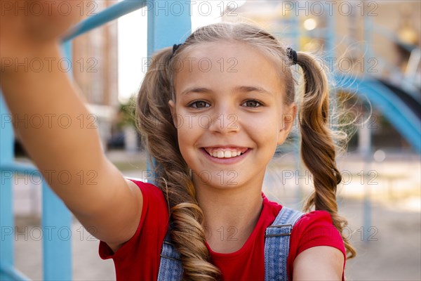 Blonde girl stretching out her hands camera