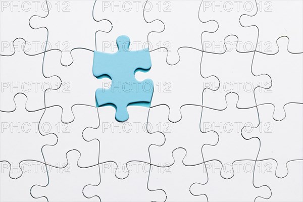 Blue piece puzzle connected with white piece backdrop