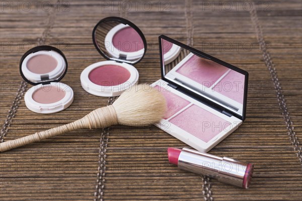 Blusher palettes pink lipstick with makeup brush placemat