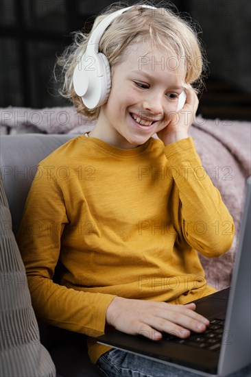 Boy couch with laptop headphones