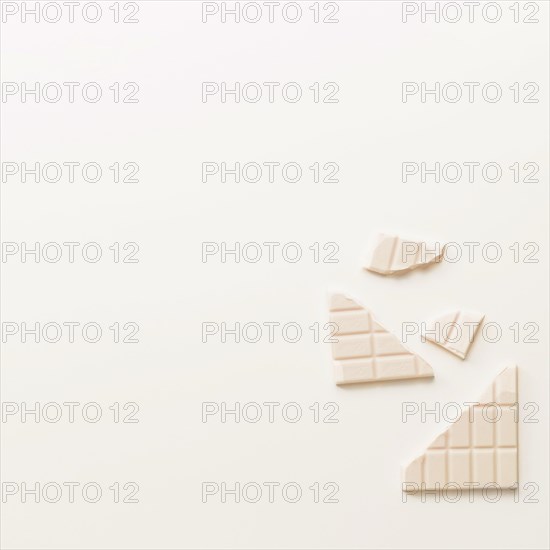 Broken chocolate bar isolated white background
