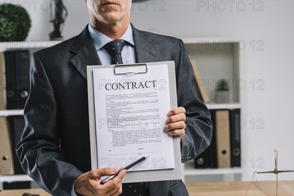 Close up lawyer showing legal contract agreement with pen