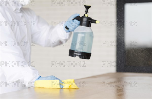 Close up man holding disinfectant bottle