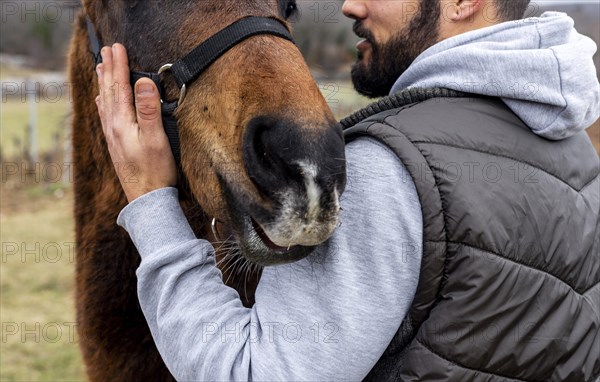 Close up man holding horse