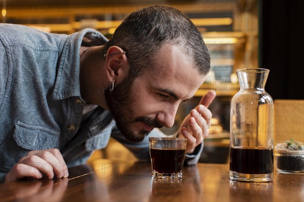 Close up man smelling cup coffee