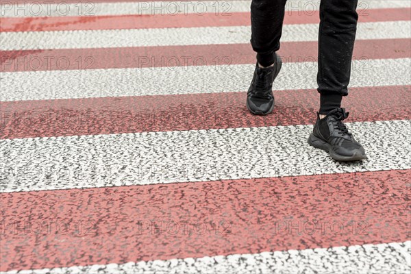 Close up men legs passing crosswalk