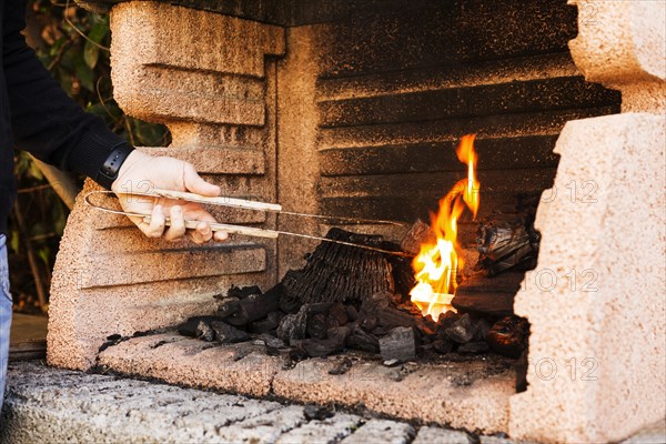 Close up person s hand burning firepit