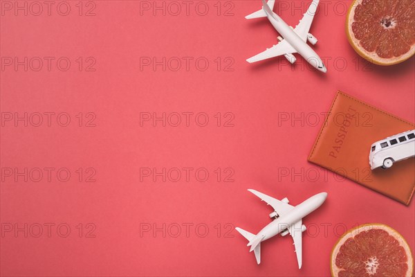 Composition toy airplanes bus passport grapefruit