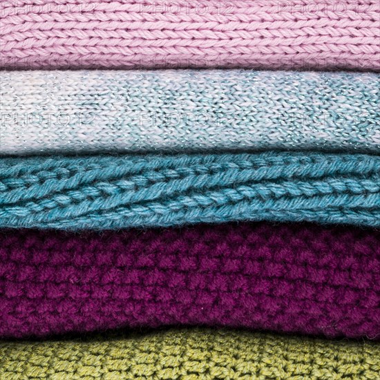 Crocheted colorful wool clothes stacked