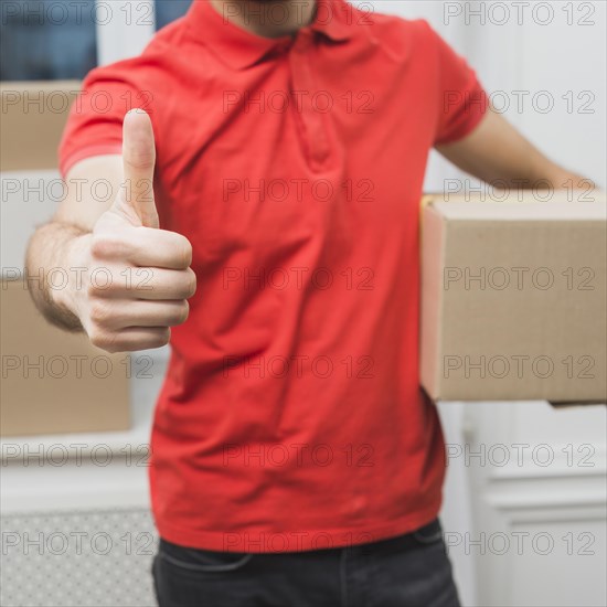 Crop courier gesturing thumb up