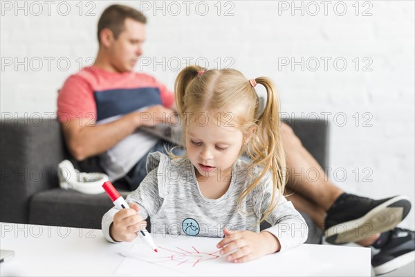 Cute girl drawing sketch with marker home