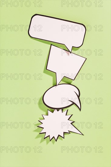 Different type white retro speech bubbles green background