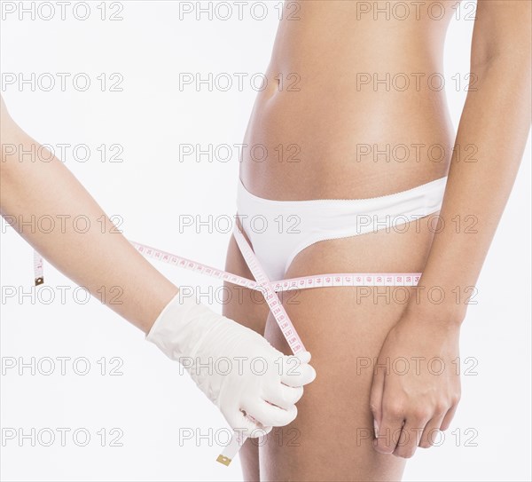 Doctor measuring woman hips