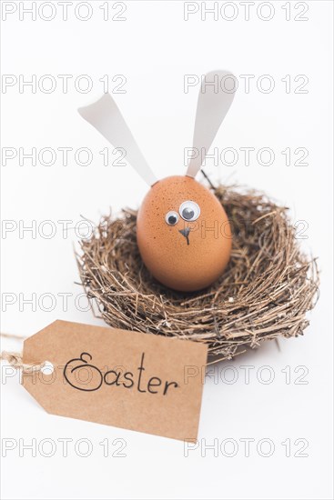 Easter inscription with egg with bunny ears nest