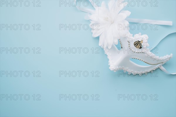 Elegant white mask blue background