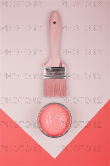 Elevated view paintbrush coral paint geometric paper background