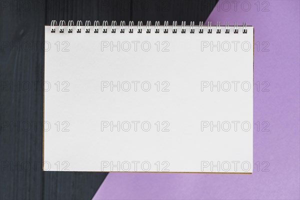 Elevated view spiral notepad colorful background
