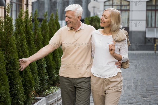 Embrace older couple taking walk outdoors
