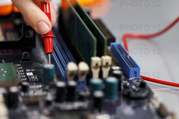 Female technician with computer motherboard