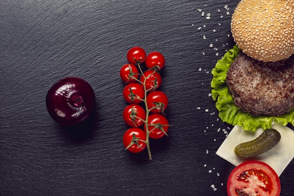 Flat lay burger ingredients slate background