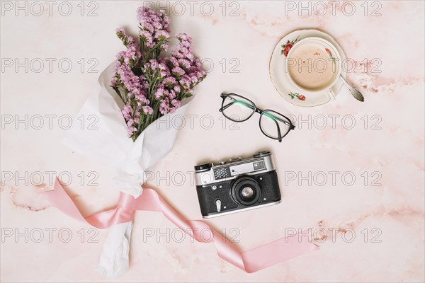 Flowers bouquet with camera coffee table
