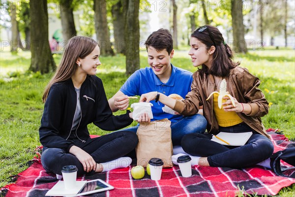 Friends sharing chips lunch time