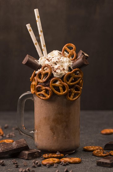 Front view chocolate milkshake with pretzels straws