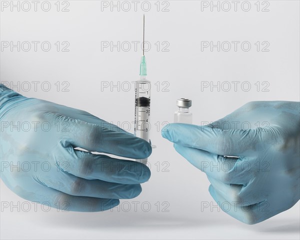 Front view doctor putting vaccine syringe