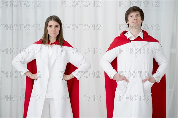 Front view doctors posing with capes
