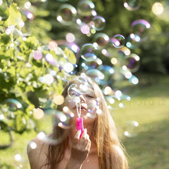 Front view girls making bubbles