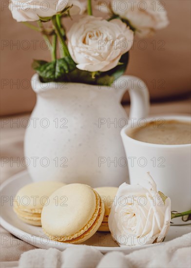 Front view morning coffee with roses macarons