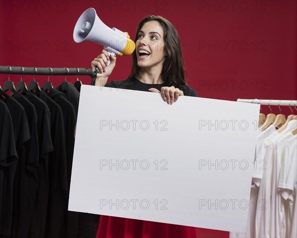 Front view smiley woman shopping shouting with megaphone