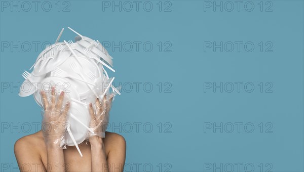 Front view woman covered white plastic tableware