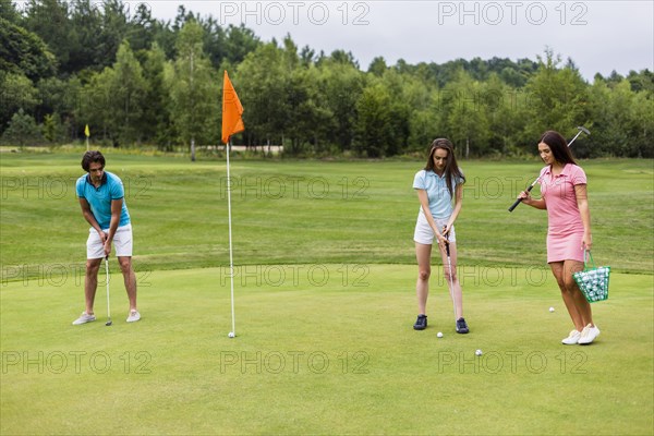 Front view young golfers playing