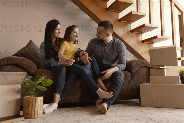 Full shot parents kid couch