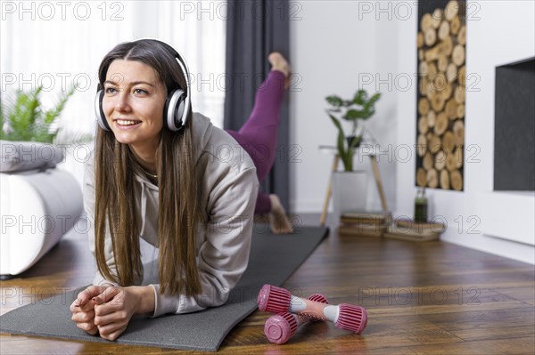 Full shot woman working out home