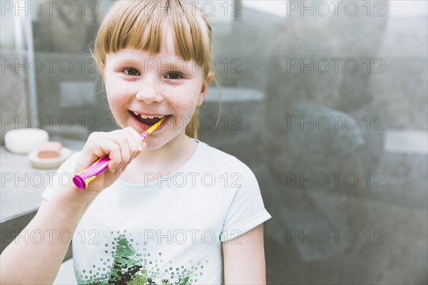 Girl brushing teeth